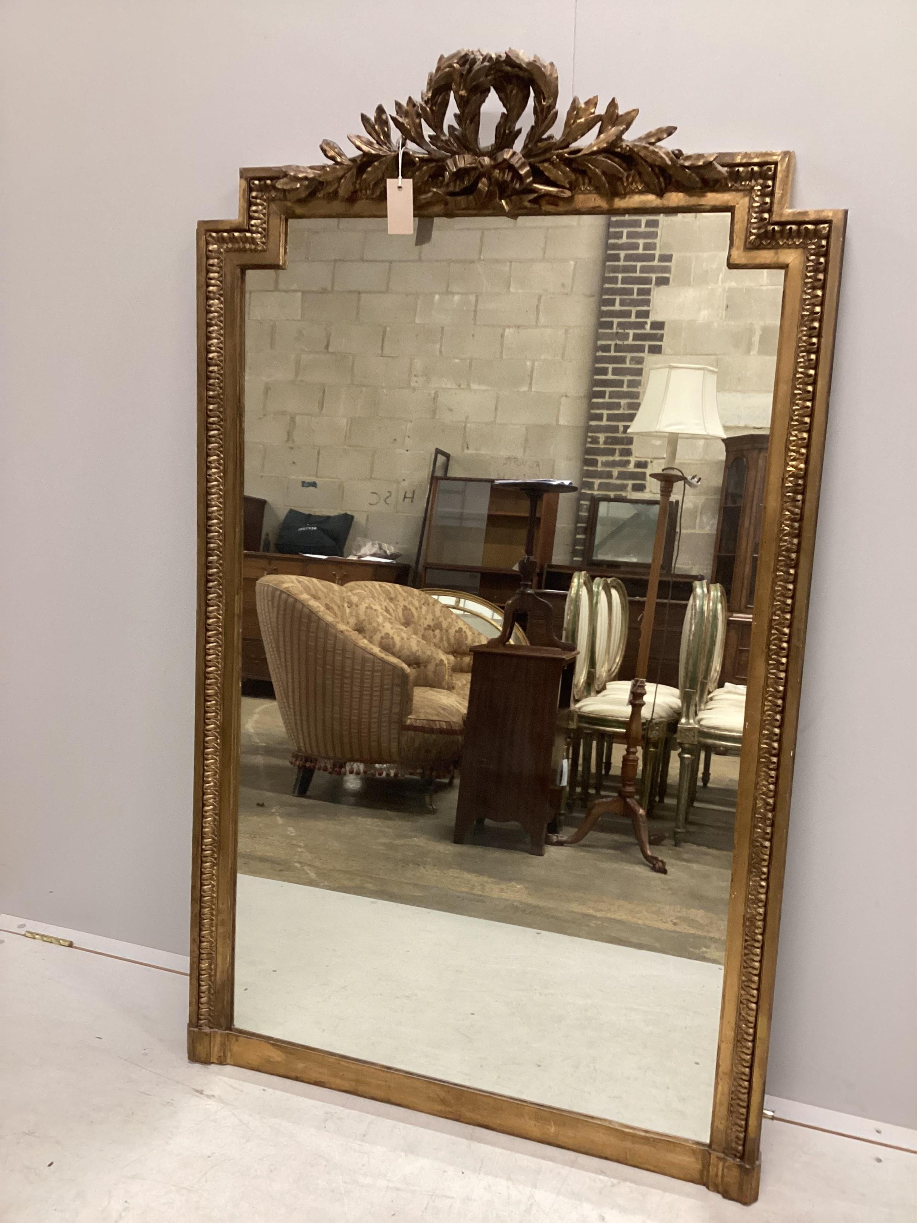 A 19th century French giltwood and composition overmantle mirror with ribbon tied leaf pediment, width 92cm, height 156cm. Condition - fair to good, has been re gilded, plate a replacement